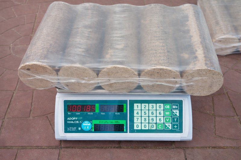 Weighed-wood-briquettes-on-scale